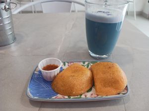 Mini empanadas and butterfly pea almond milk at Frambuesa Pastelería Vegan in Bogota