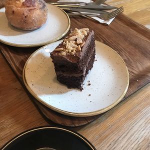 Chocolate and peanut slice (doughnut in the background)   at Pinkmans in Bristol