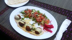 Amazing falafel plate! four falafel balls on a bed of delicious hummus.. fresh and tasty! Everything is made from scratch daily, no cans or preservatives. plates includes side of heavenly garlic sauce and in house baked lavash (flat) bread. at Aroma House in Kampot