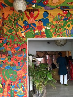 Beautiful space with lots of art and varied seating (tables, floor cushions). at Jatra Biroti in Dhaka
