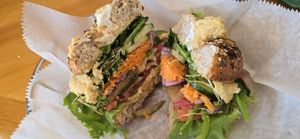 "Hummus and all the Veggies" on a toasted While Wheat  w/Italian Seasonings Bagel which had to be remade because it got cut with a knife that left cream cheese smear on vegan orde at Bagel Cafe in Camden