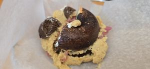 Toasted Rye (was actually pumpernickle) Bagel with hummus, Sprouts, Pickled Red Onion had to be remade because it got cut with a knife that left a cream cheesesmear on vegan order at Bagel Cafe in Camden
