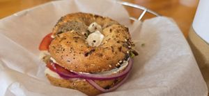 Toasted Whole Wheat Italian Seasonings Bagel with Tofutti (R), Tomato, Red Onion, and Sprouts at Bagel Cafe in Camden