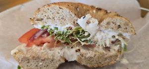 Toasted Whole Wheat Italian Seasonings Bagel with Tofutti (R), Tomato, Red Onion, and Sprouts at Bagel Cafe in Camden