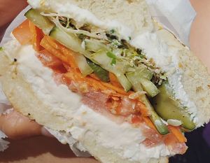 Sesame bagel, tofutti, tomato, pickles, sprouts, and carrots at Bagel Cafe in Camden