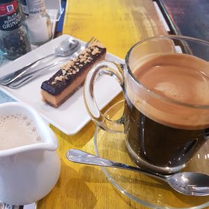 Black Coffee, Almond Milk and Crunchbox Peanut Butter Bar at Wilson's in Phuket