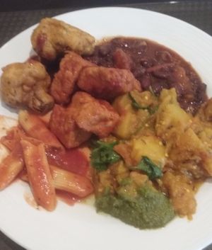 Lunch buffet plate (vegan): BBQ tofu, pasta, aloo baingan, cauliflower pakora at Govinda's in Houston