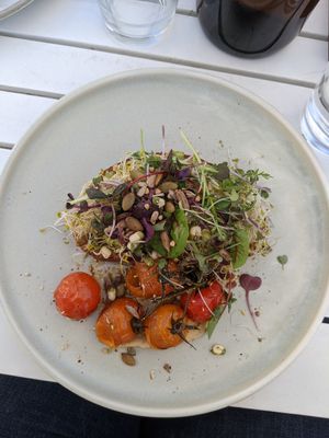 Avocado on toast with roasted tomatoes and hummus at Queenscliff General Store Cafe in Queenscliff