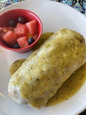 Verde sauce drenched over vegan breakfast burrito. W/ a side fruit    at The Local in Prescott