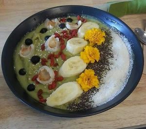 Coconut and matcha bowl with seasonal fresh fruit, dried fruit, cacao granola, coconut flakes and chia gel at Nagev in Evandale