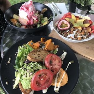 Pancakes and smoothie bowl behind and an avocado on toast in the front at Mr Black Juicery in Berwick