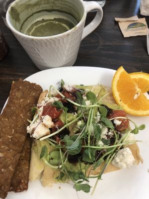Brunch - avocado toast on focaccia bread with side order of tempeh bacon  at Grow Your Roots Cafe in Ottawa