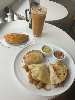 Quesedillas, empanada, iced oat milk latte at De Aca in San Jose