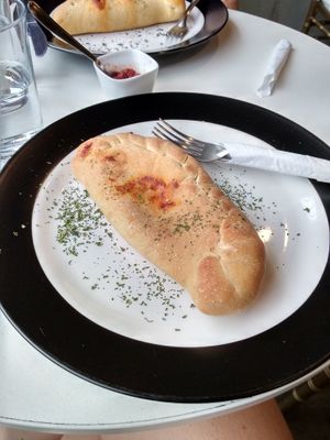 Vegan calzone with almond cheese at De Aca in San Jose