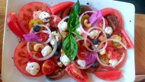 tomato salad with cashews and vegan cheese  at Gusto Ristobar in Sevilla