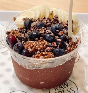 Cacao For Now Acai Bowl, made with a base of açaí, banana 🍌, blueberries, cacao, and topped with almond butter, Raw Press grawnola, banana, blueberries and cacao nibs! at Raw Press in South West London