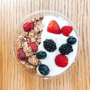 Our granola bowl with coconut yoghurt and berries, topped with our raspberry & rose Raw Press Beauty granola at Raw Press in South West London