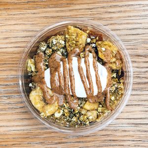 Start your day right with our apple compote pot! A granola bowl with coconut yoghurt, an autumn fruit compote, almond butter, and our uplifting adaptogenic Raw Press Happy granola  at Raw Press in South West London