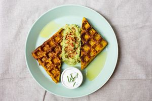 Sweetcorn & Turmeric Waffle, served with smashed avocado, tomato salsa and cashew sour cream at Raw Press in South West London