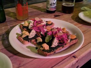 Pretty bruschetta topped with delicious macadamia nut cheese, basil pesto, and pickles. at Tandana in Quito