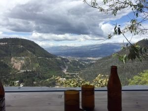 Gorgeous view from restaurant seats.  "Cerveza artisanal" and recycled glasses on top of the table made out of reclaimed/recycled wood.  Incredible location! at Tandana in Quito