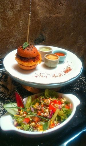 mini carrot chickpea burger with buddha salad and fresh herbed dip sauces at bARACA in Kampot