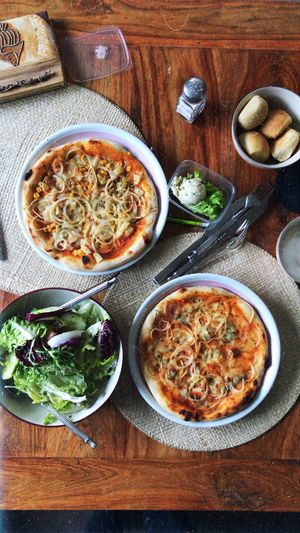 The upper left pizza is vegan. Bread, spread and salad are vegan as well.   at Casa Tua in Bergkamen