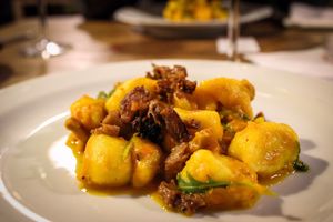 gnocchi with pumpkin sauce, saffron, rocket, rawmesan and seitan at Incruenti in Prague