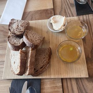 Bread with miso butter and glass of broth  at BROEI in Utrecht