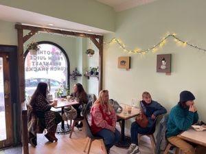 Three small tables and 4 stools at a counter for seating   at Juniper Kitchen in Dover