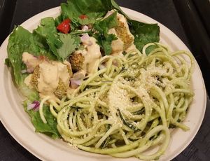 Combo plate zucchini "noodles" , walnut pesto topped with cashew Parmesan and raw, vegan falafel with paprika tahini. at True Earth Juicery & Vegan Cafe in North Hollywood
