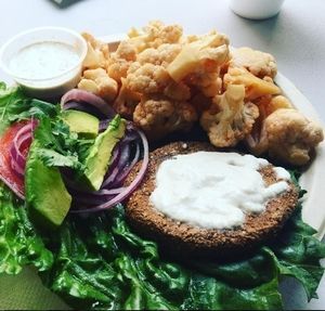 True Earth Burger combo , add avocado, with Buffalo Cauliflower.  at True Earth Juicery & Vegan Cafe in North Hollywood