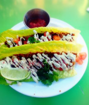 Taco with walnut 'meat' with some sort of cream, diced tomatoes, cilantro, and a spritz of lime. Interesting texture and delicious.  at True Earth Juicery & Vegan Cafe in North Hollywood