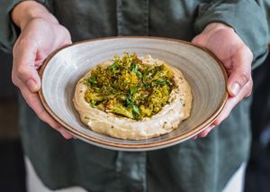 Cauliflower Hummus | Coopernatural chickpea hummus, Za’atar spiced roasted cauli ower, spiced Chermoula sauce, cilantro, Sítio do Moinho artesanal pita bread. at Teva in Rio De Janeiro