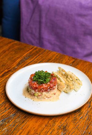 Fresh tomatoes, red onions, fresh hearts of palm, avocado, capers, nori dust, arugula, rosemary crackers. at Teva in Rio De Janeiro
