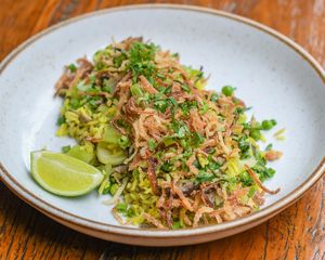Lemongrass and turmeric Jasmine rice, ginger, shiitake, peas, roasted chinese cabbage or bokchoy, cilantro, scallions, fried onions, lime wedges. at Teva in Rio De Janeiro