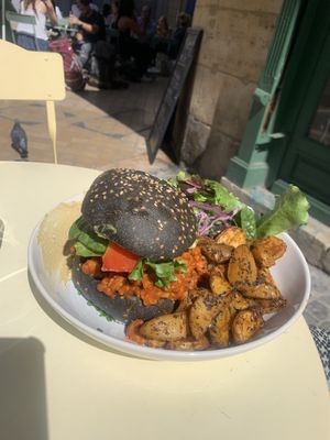 Bad boy burger (charcoal bun with avocado, tomato, roasted aubergine in bbq sauce with a side roasted potato, salad, hummus) at Kitchen Garden in Bordeaux