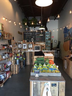 Inside the market with a view of the juice/smoothie menu at Celis Produce in West Palm Beach