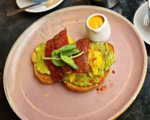 Avo smash, tofu scramble, and vegan bacon with sriracha cashew mayo all on toasted sourdough at Rose & Grant's in Glasgow