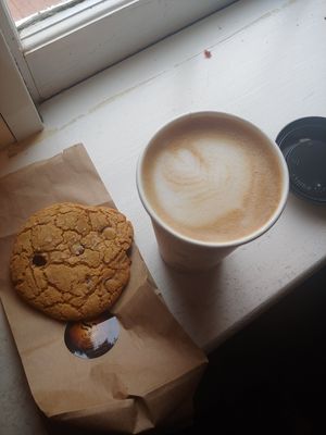 Oatmilk latte and salted chocolate chip cookie at Agora Downtown Coffee Shop in Fredericksburg