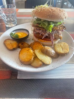 Mockme burger (chickun and rice paper bacon) with a side of cheesy sauce  at Particle Cafe in Avondale Heights