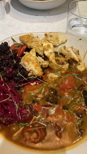 Katsu curry - but breadcrumbed tofu soft in a sea of watery curry soup Ona pile of gloopy black rice   at Stem & Glory in Cambridge