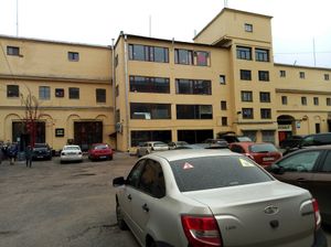 arcade museum on the left and head to the right side where the white sign with black writing is.   at Hood - Konyushennaya in St Petersburg