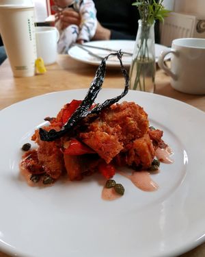 tomato bread bake with capers and kale at Riverside Sourdough Cafe @ the embassy in Cardiff