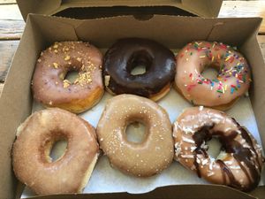From top left: blueberry french toast, plain chocolate glaze, the Homer, cinnamon, maple, and almond joy at Dun-Well Doughnuts in New York City