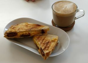 Vegan cheese and seitan toastie and flat white at Blanche Bakery in Cardiff