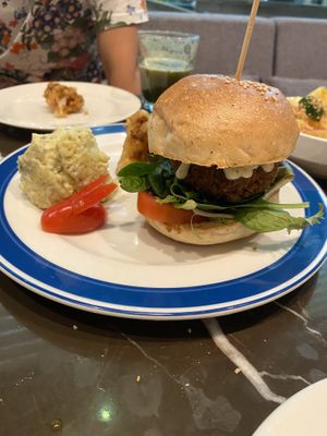 Burger and a side of potato salad   at Real Food 真食 - South Beach in Central Singapore