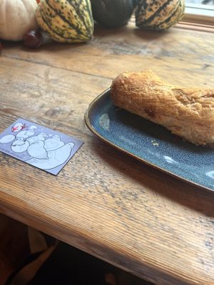 Currywurst sausage roll with cute pigeon themed rewards card 🐦  at Tofurei in Norwich