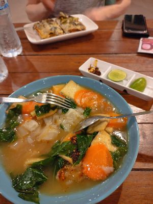 Flat rice noodles (lardna) and lasagna at Govinda's Restaurant in Krabi