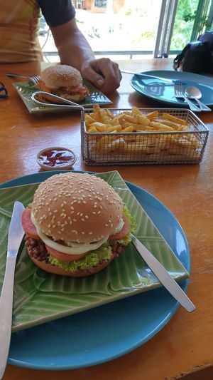 Soy burger (falafel burger in background) at Govinda's Restaurant in Krabi